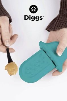 a person is holding a plastic scooper with food in it's hand and the word diggs above them