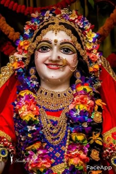 a close up of a person wearing a costume with flowers on the head and face