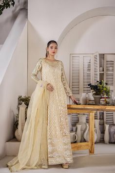 Indulge in the epitome of elegance with our cream-coloured summer soiree dress. Crafted from soft, flowy net fabric, this trendy yet timeless piece features intricate French knots, shimmering crystals, and lustrous pearls. The exquisite thread work adds a touch of glamour, ensuring you shine at any event. Fabric: Shirt: Soft Pure Flowy Net Pants: Cotton Silk Colour: Beige Size: Model is wearing size X-small Disclaimer: Please note that the actual product and colors may appear different from the Beige Organza Wedding Dress, Sheer Cream Organza Dress, Cream Organza Dress With Dupatta, Elegant Cream Organza Dress, Cream Dresses With Sheer Dupatta In Organza, Elegant Cream Dress With Sheer Dupatta, Cream Organza Dress With Sheer Dupatta, Elegant Cream Dress With Dupatta, Cream Party Dress With Sheer Dupatta