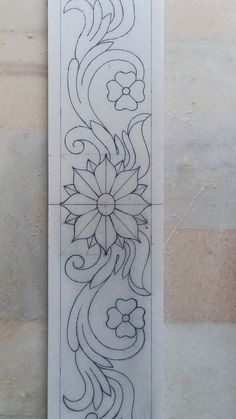 the back side of a bookmark with flowers and swirls drawn in black ink