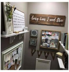 a room that has some pictures on the wall and other items hanging from the shelves