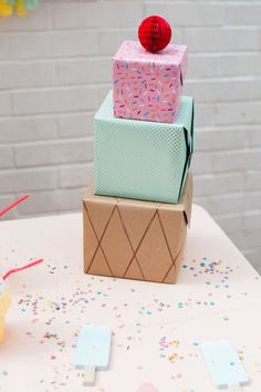 three boxes stacked on top of each other with confetti and sprinkles