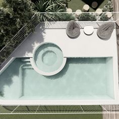 an aerial view of a swimming pool with lounge chairs