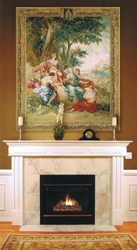 a fireplace in a living room with a painting on it's wall above the fire place