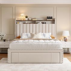 a white bed sitting in a bedroom on top of a hard wood floor next to a lamp