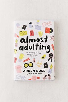 the book almost adulting by arden rose is sitting on top of a white surface