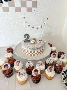 a cake and cupcakes are arranged on a table with the number twenty two