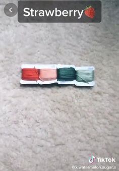 there are three spools of yarn on the floor with strawberries in them