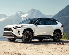 a white toyota rav parked on top of a mountain