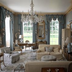 a living room filled with furniture and a chandelier