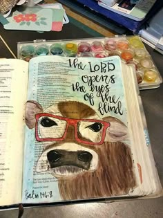 an open bible with a dog wearing glasses