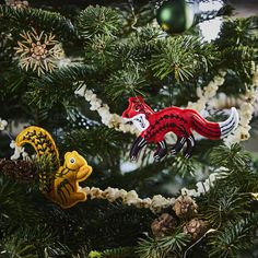 two ornaments are hanging on the christmas tree