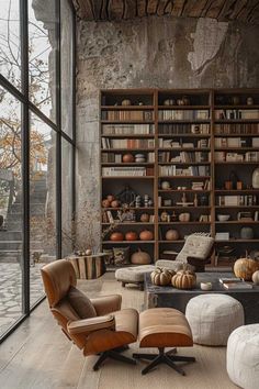 a living room filled with lots of furniture and bookshelves next to a window