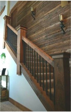 a wooden stair case next to a window in a house