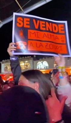 a group of people holding up signs in the air