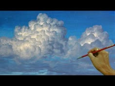 a painting of a hand holding a pencil in front of a cloud filled with white clouds