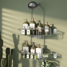 two tiered shower caddy with soaps and lotions on the shelves in front of a cactus