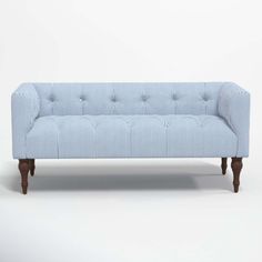 a blue and white striped couch with wooden legs