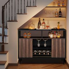 a bar with liquor bottles and glasses on it in front of a stair case next to the stairs