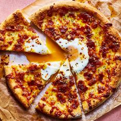 the pizza is cut into four pieces and has an egg on one side, and cheese on the other