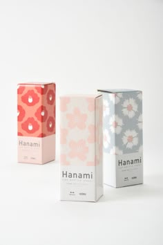 three boxes with different designs on them sitting next to each other in front of a white background