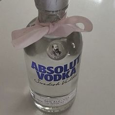 an empty vodka bottle with a pink bow on it