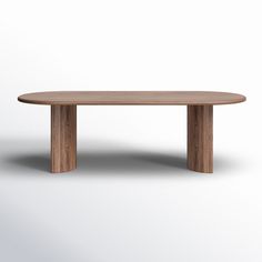 an oval wooden table sitting on top of a white floor