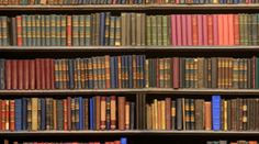 an old bookshelf filled with lots of different types of books on it's shelves