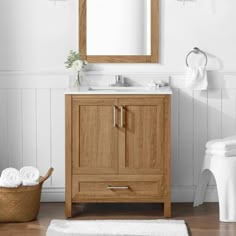 a bathroom with a sink, mirror and towel rack on the wall next to it