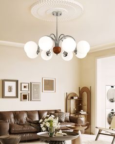 a living room filled with furniture and pictures on the wall above it's coffee table