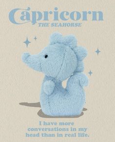 a blue stuffed animal sitting on top of a white sheet with the caption capricon the seahorse