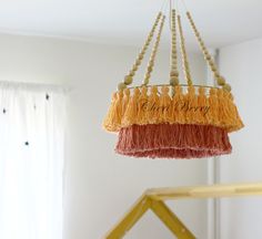 a chandelier with tassels hanging from it's sides in a room