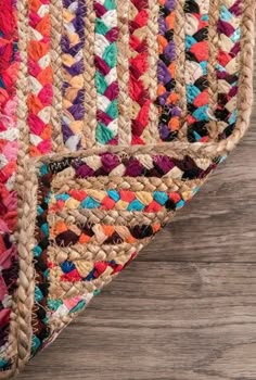 multi colored braided rug on wooden floor