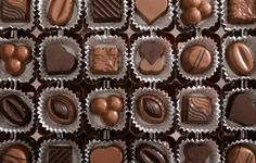 many chocolates are arranged in the shape of hearts