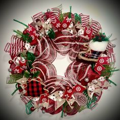 a red and white christmas wreath with ornaments