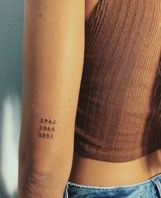 a woman with a tattoo on her arm that reads see, do, not, love