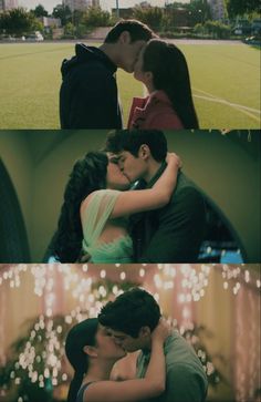 two people kissing each other in front of a soccer field with lights on the grass