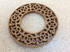 a circular object made out of wood sitting on a counter top next to a tile floor