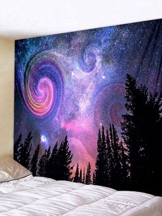 an image of a wall hanging on the side of a bed with trees and stars