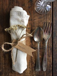 silverware and napkins are laid out on a wooden table