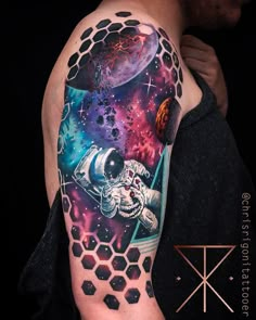 a man with a space tattoo on his arm