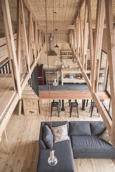 a living room filled with furniture and wooden walls