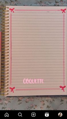 an open notebook with the word coquette written in pink and on top of it