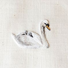 a drawing of a swan on a piece of linen