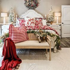 a bedroom decorated for christmas with red and white decor