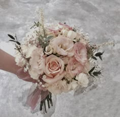 a bridal bouquet with pink and white flowers