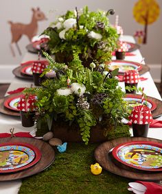 the table is set with plates and place settings for children's birthdays or baby's first birthdays