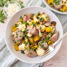 two white bowls filled with food on top of a table