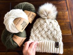 two balls of yarn sitting next to each other on top of a wooden floor,