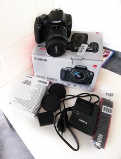 three cameras sitting on top of a table next to each other with the box open